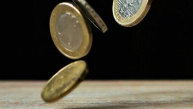 Dynamic shot of euro coins appearing to float, symbolizing active economy.