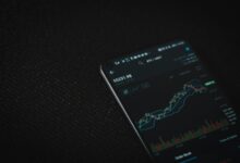 black android smartphone on black textile