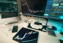 Stock charts are displayed on multiple screens.